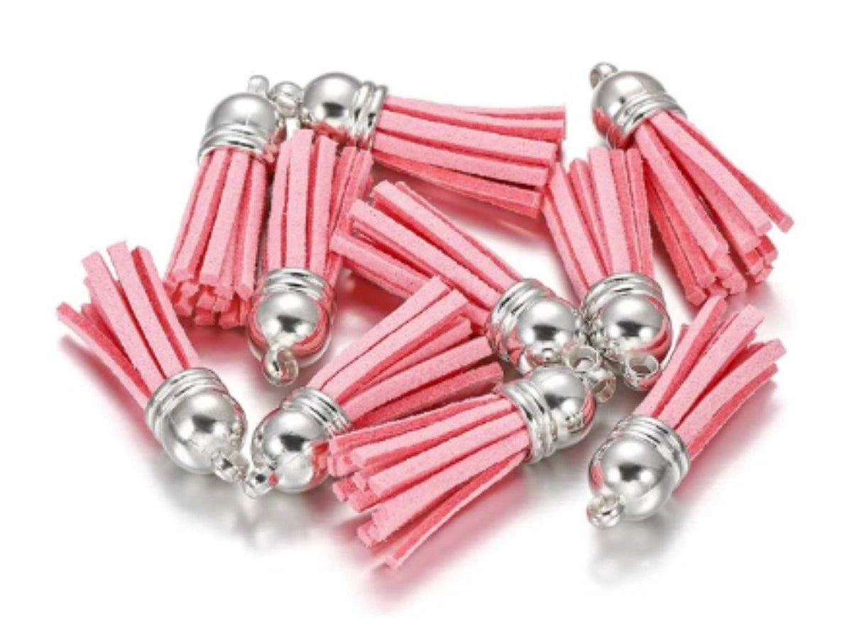 Pile of 38mm rose leather fringe tassels with silver-tone caps and loops