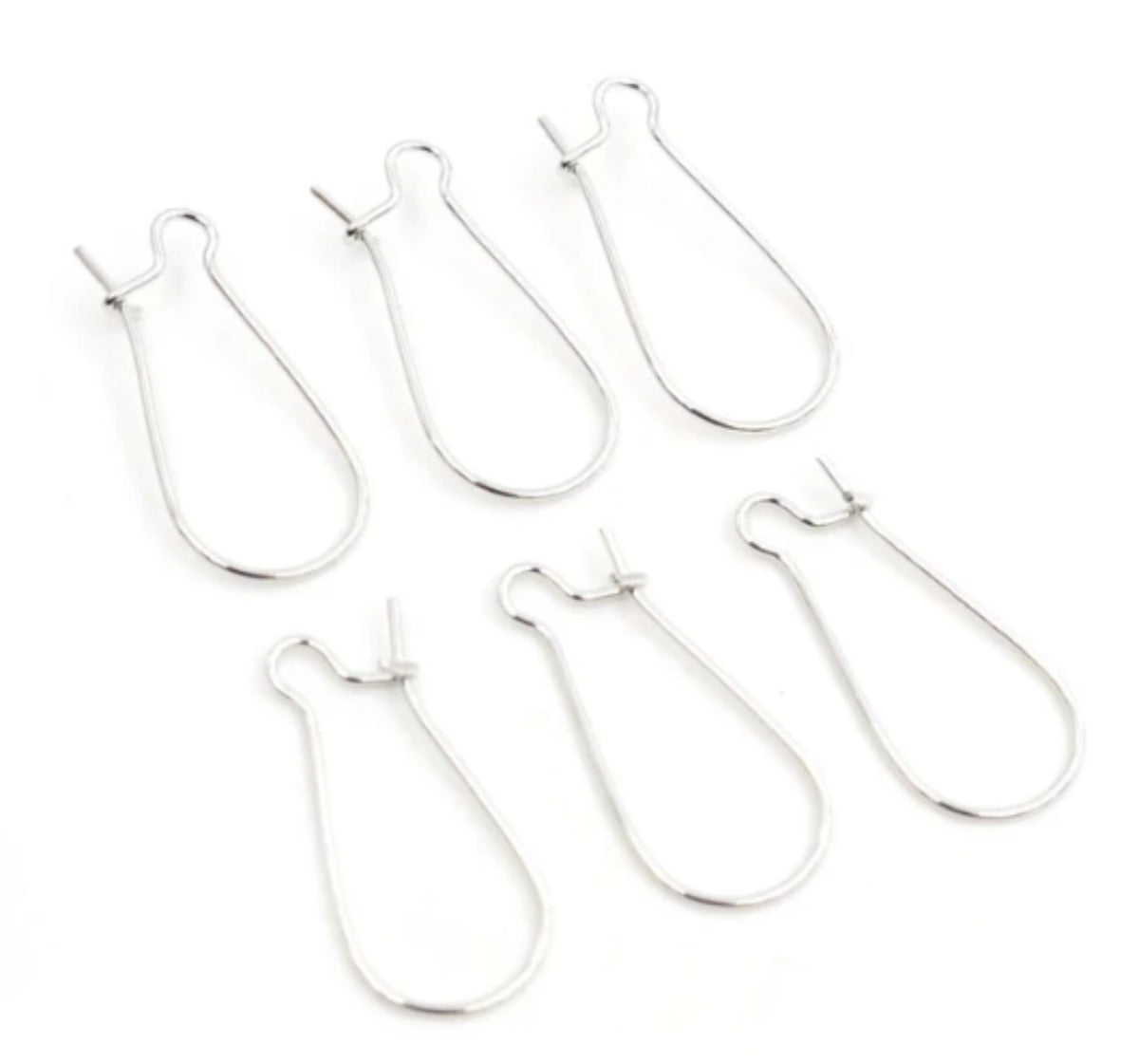Group of silver kidney wire earring hooks in three sizes, laid out on a white background
