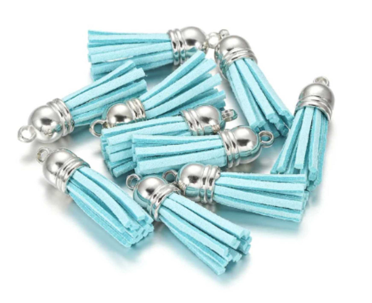 Pile of 38mm sky blue leather fringe tassels with silver-tone caps and loops
