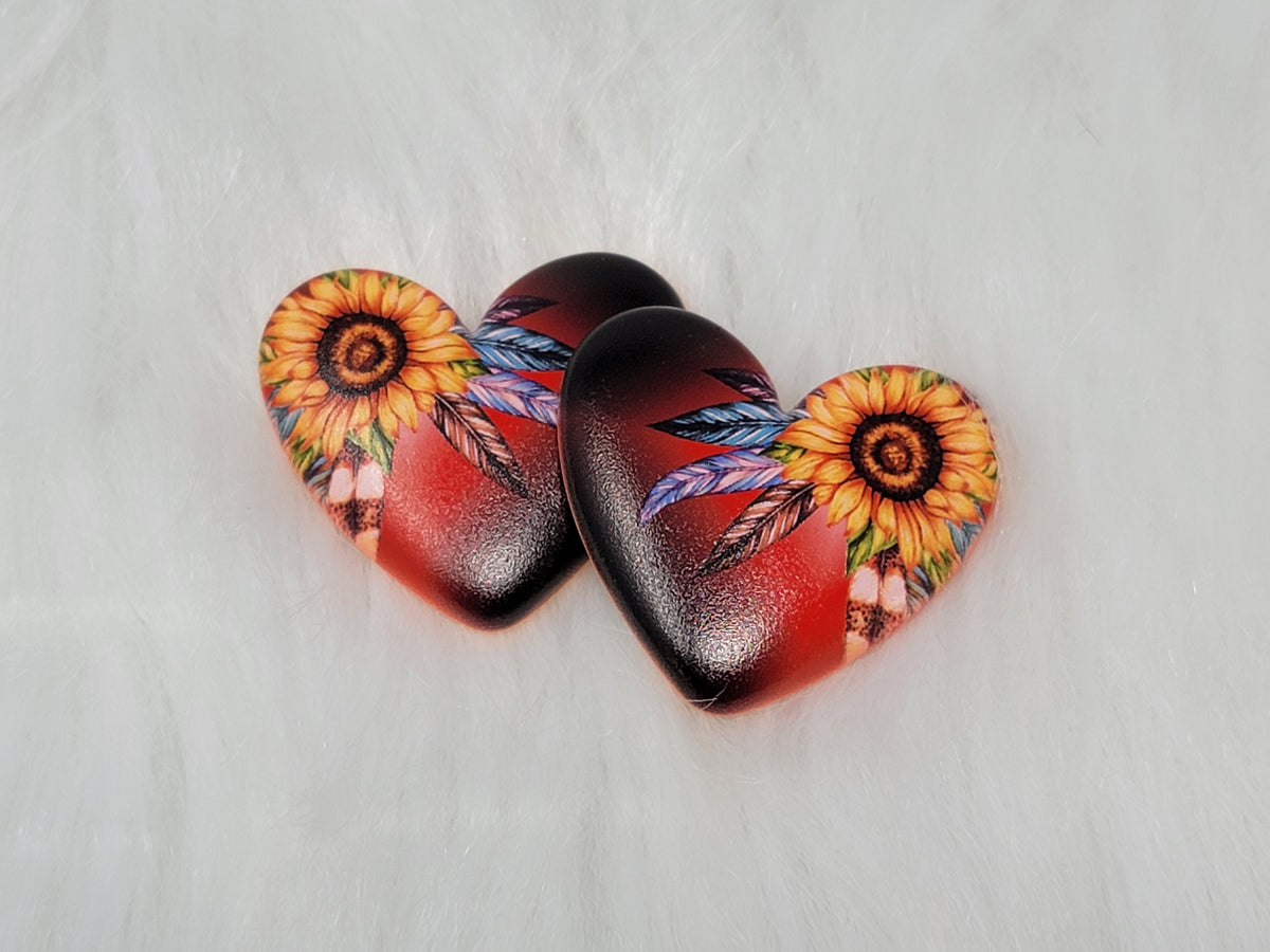 Pair of 37mm resin heart cabochons (cabs) with a sunflower and feathers on a red and black blend