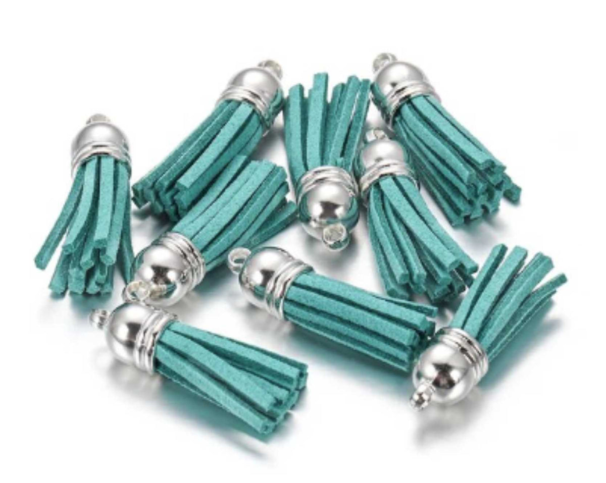 Pile of 38mm turquoise leather fringe tassels with silver-tone caps and loops
