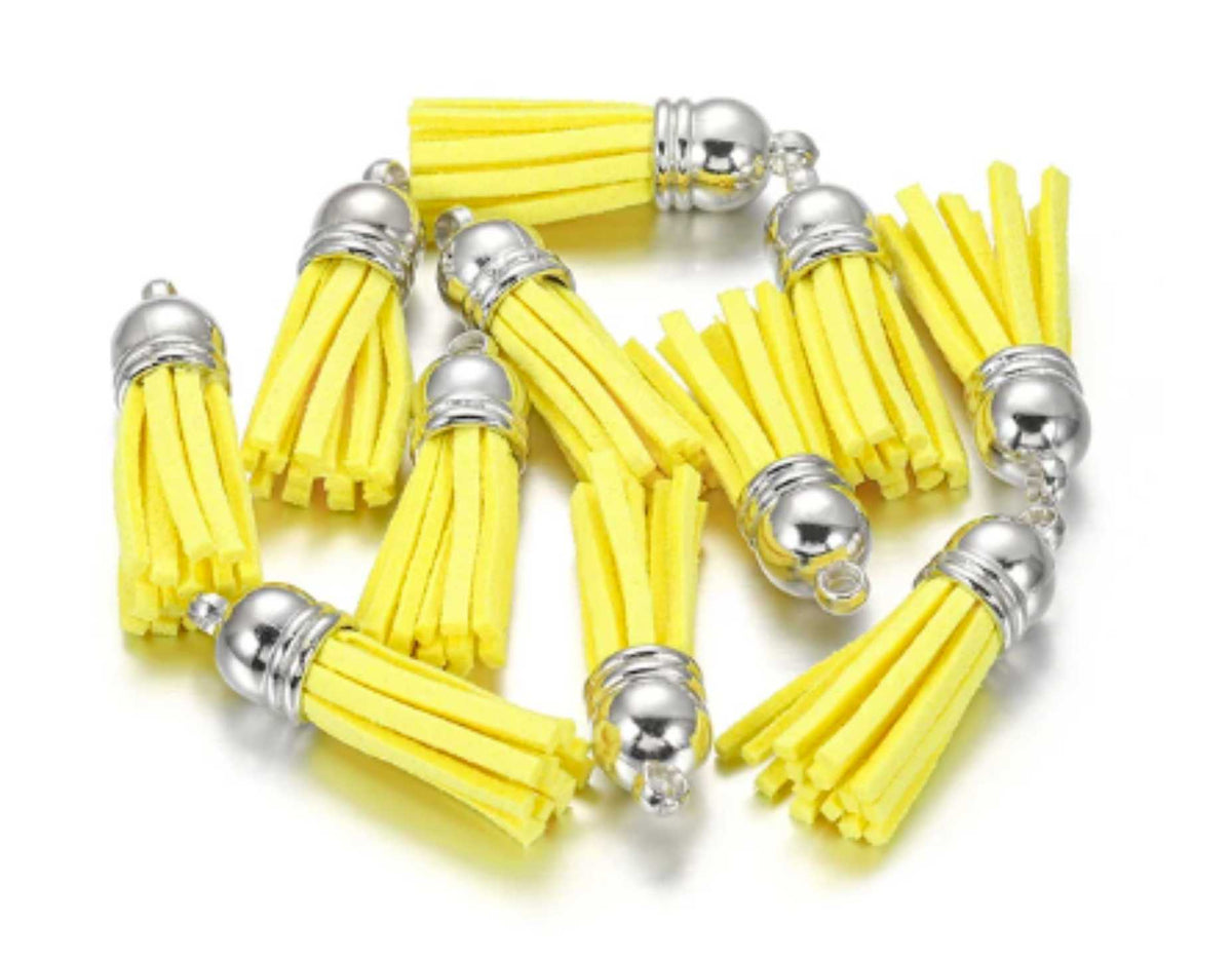 Pile of 38mm yellow leather fringe tassels with silver-tone caps and loops
