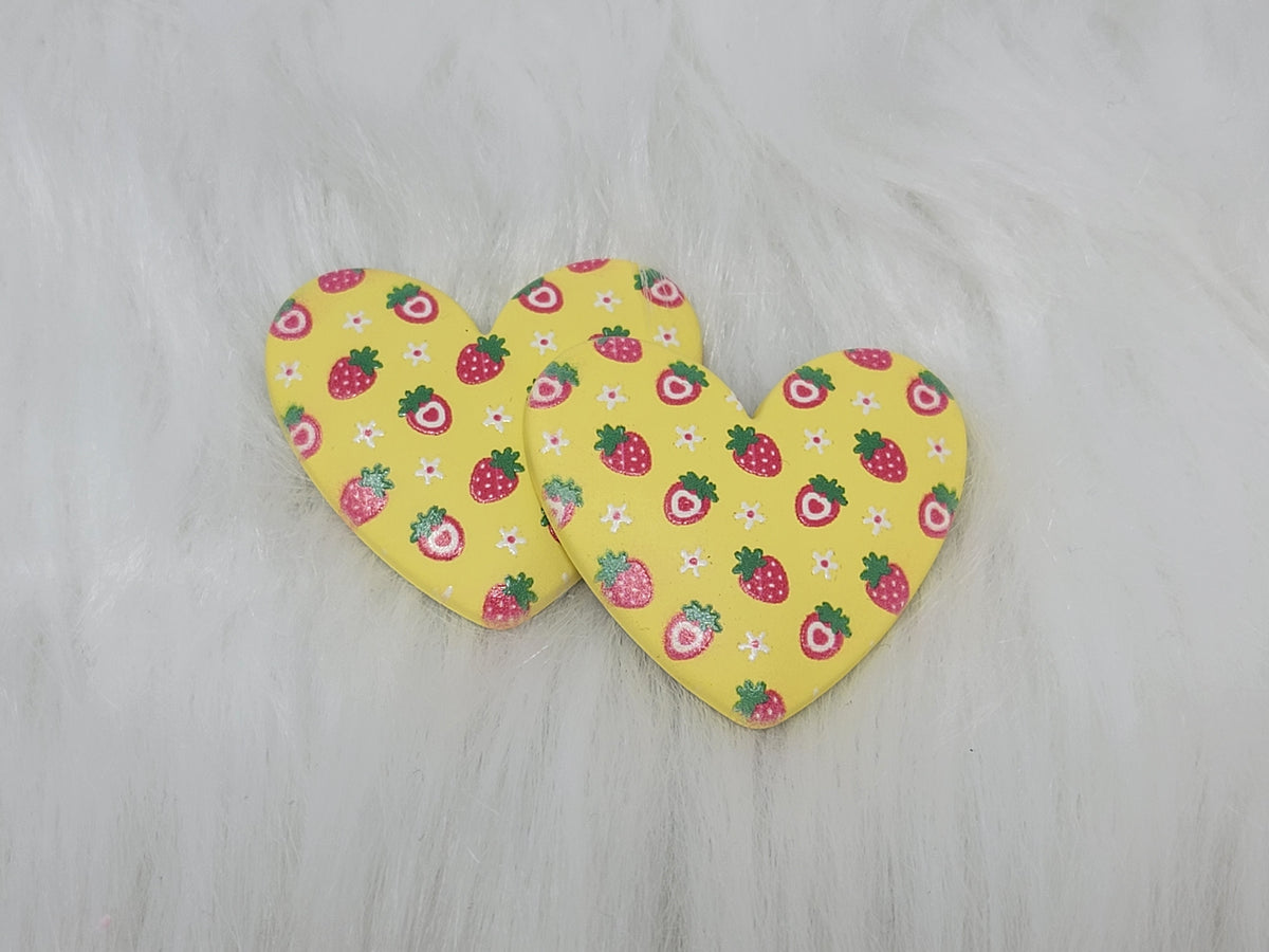 Pair of 37mm resin heart cabochons (cabs) in yellow with a red strawberry and white flower pattern