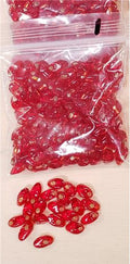 Bag of long magatama beads in red marked #1, with loose beads in front