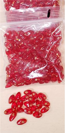 Bag of long magatama beads in red marked #1, with loose beads in front