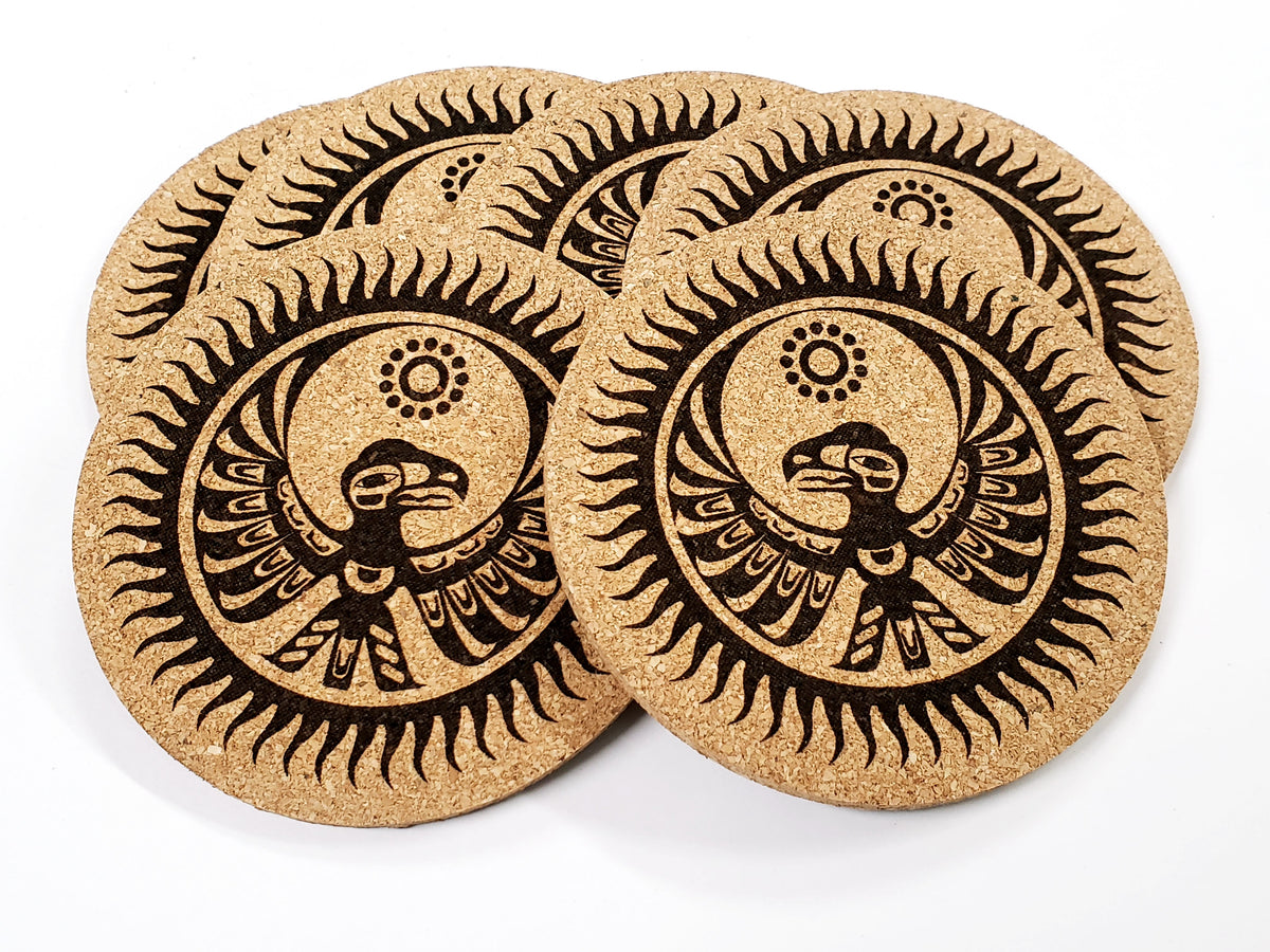 Stack of round cork coasters printed in black with a thunderbird with sun rays