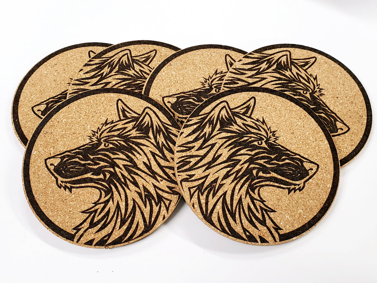 Stack of round cork coasters printed in black with two wolf heads
