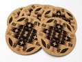 Stack of round cork coasters printed in black with a geometric diamond pattern