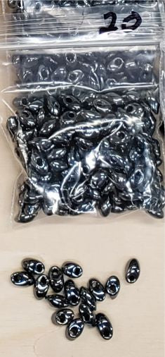 Bag of long magatama beads in gunmetal marked #20, with loose beads in front