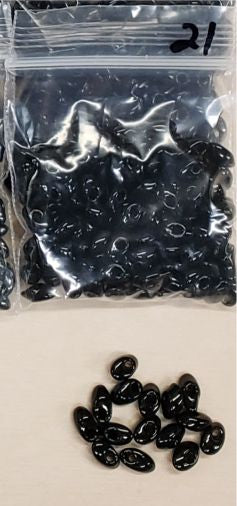 Bag of long magatama beads in black marked #21, with loose beads in front