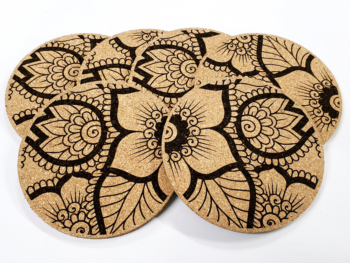 Stack of round cork coasters printed in black with large outlined flowers