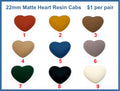 Nine pairs of 22mm matte resin heart cabochons (cabs) in terracotta, mustard, brown, tan, blue, mauve, green, black, cream