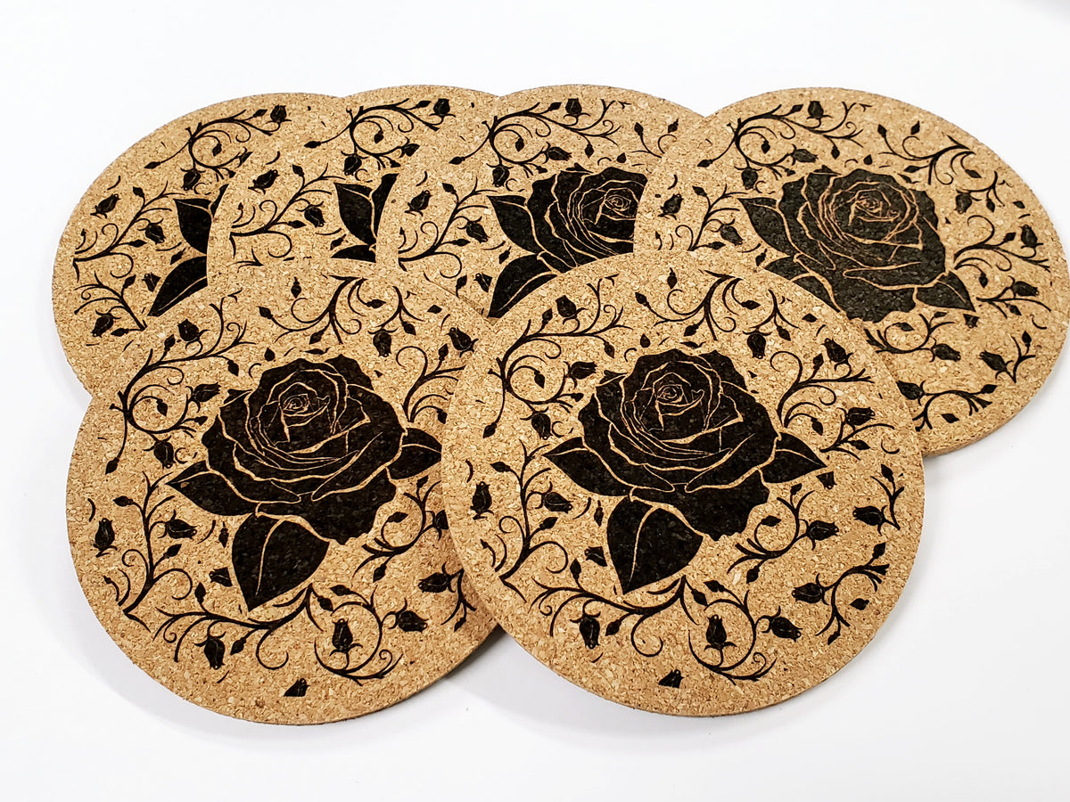 Stack of round cork coasters printed in black with black roses