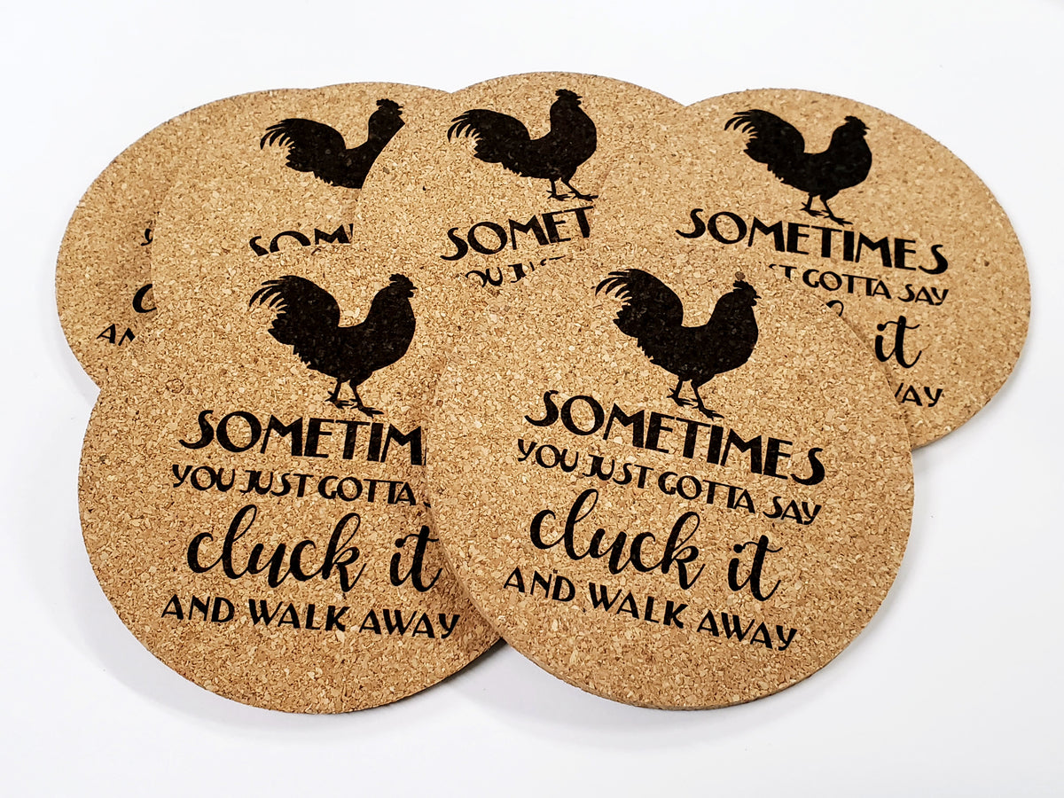 Stack of round cork coasters printed with the words 'Sometimes you just gotta say cluck it and walk away' with roosters