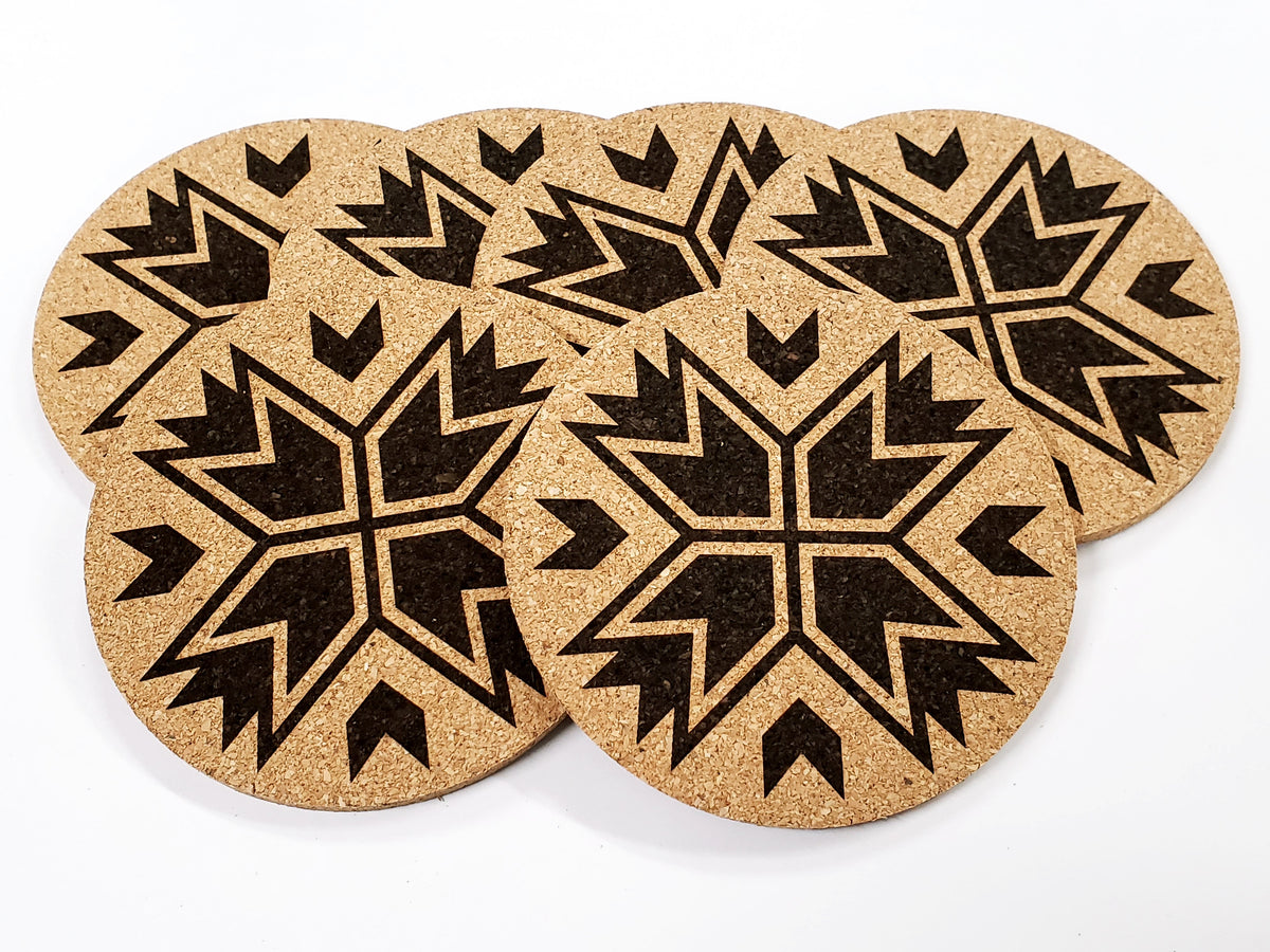 Stack of round cork coasters printed in black with an eight-point star pattern