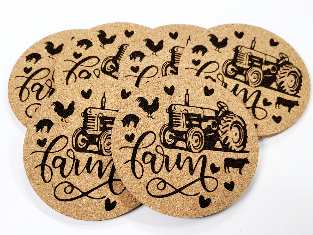 Stack of round cork coasters printed in black with a tractor and the word farm