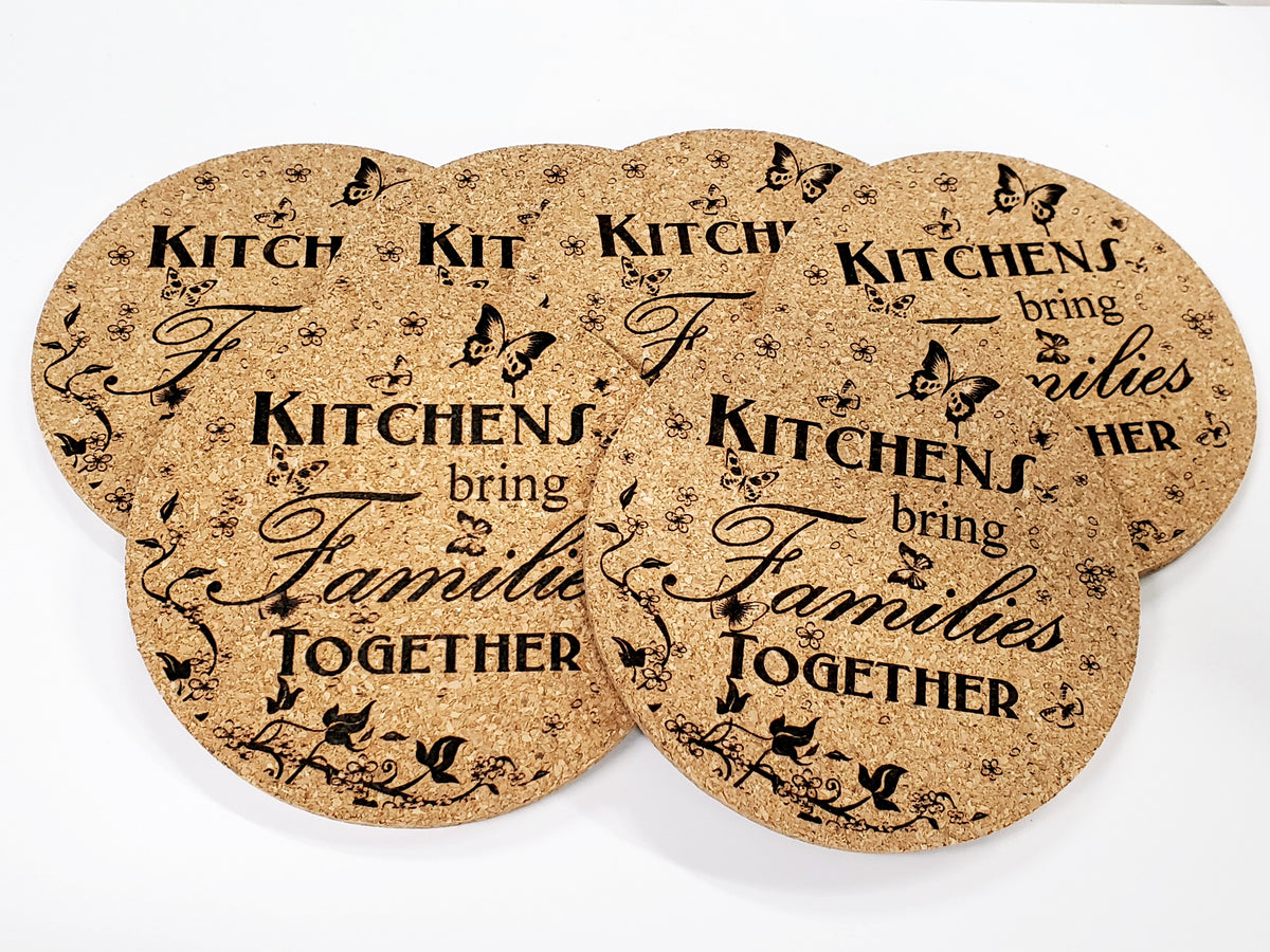 Stack of round cork coasters printed with the words 'Kitchens bring families together'