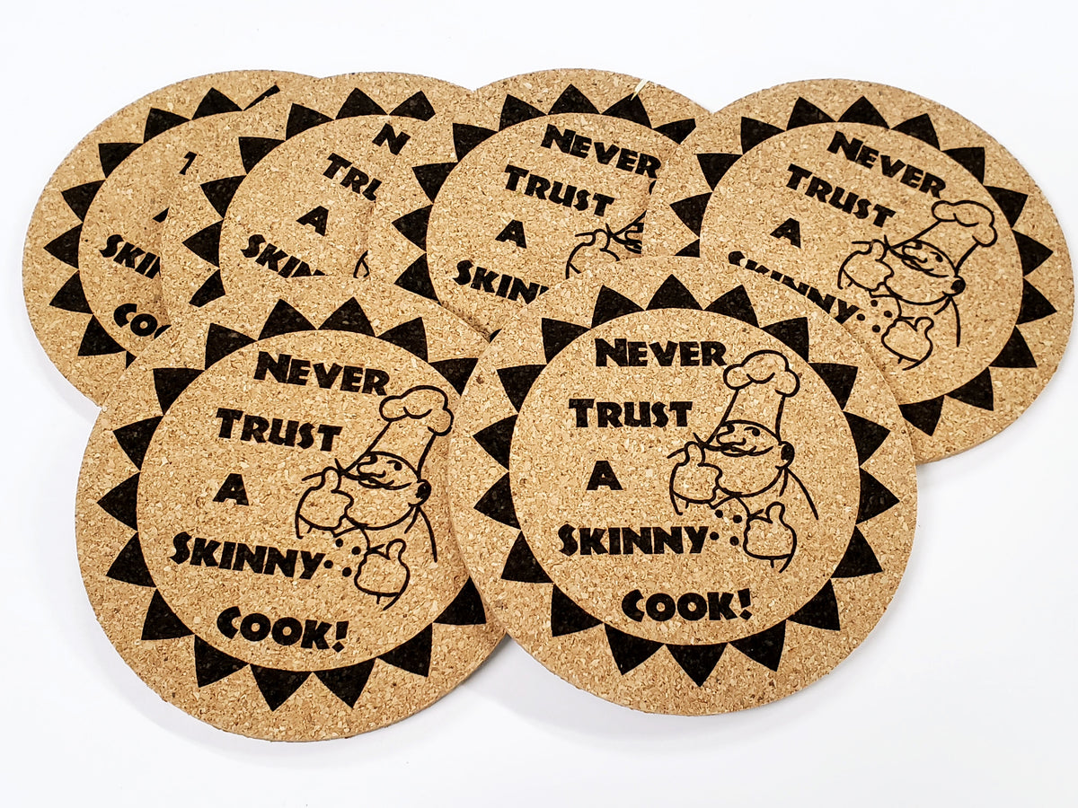 Stack of round cork coasters printed with the words 'Never trust a skinny cook!'