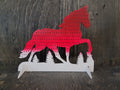 Horse-shaped earring display rack with rows of holes, in dark red to red to white