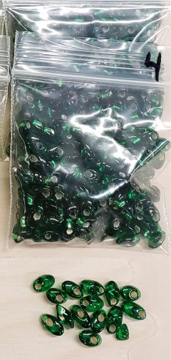 Bag of long magatama beads in emerald marked #4, with loose beads in front