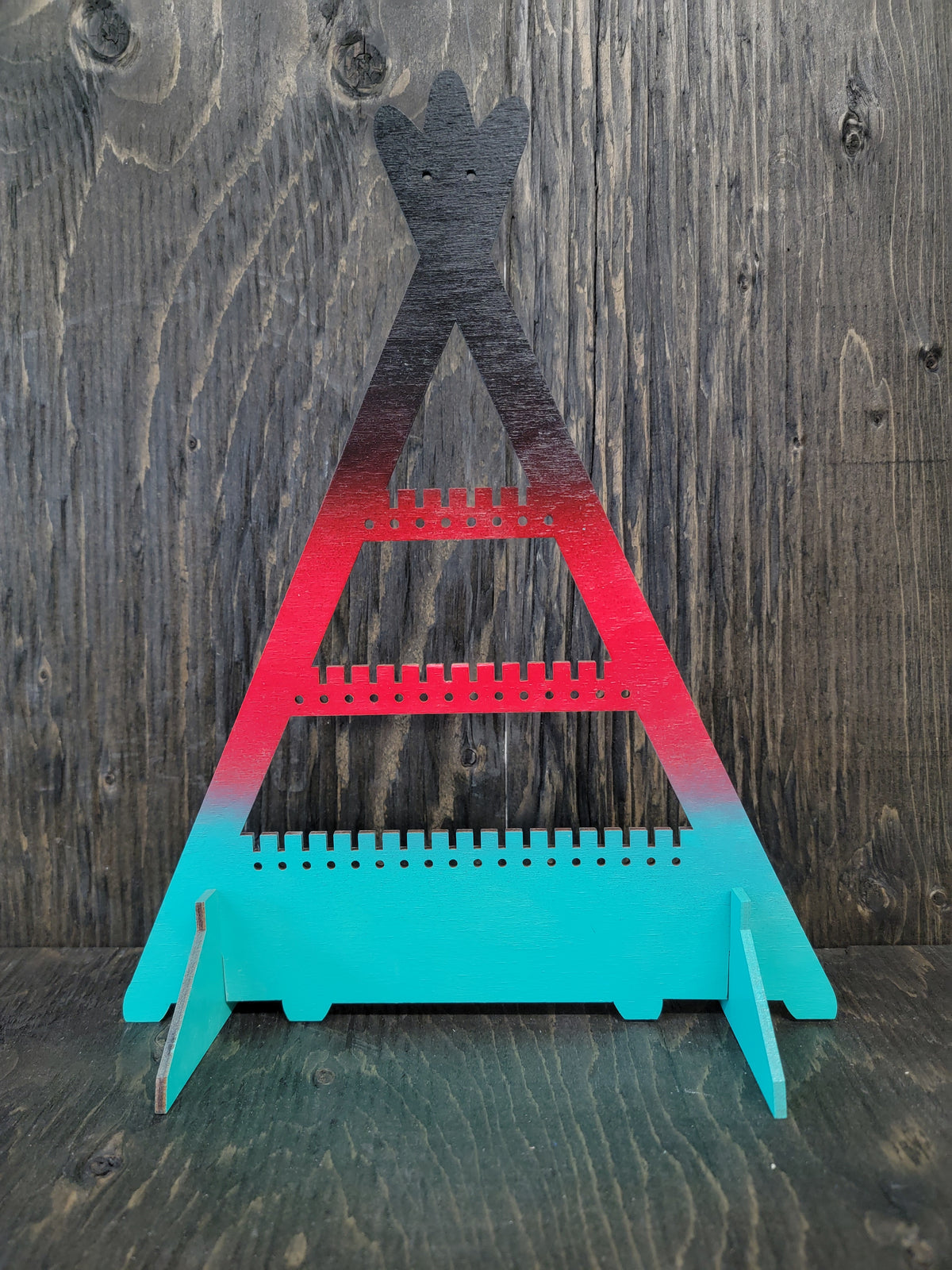 Tipi-shaped earring display rack with rows of holes, in black, red and turquoise