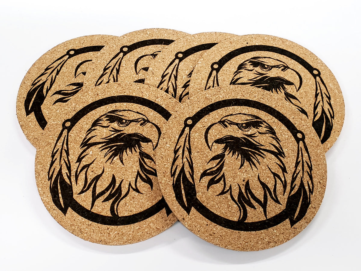 Stack of round cork coasters printed in black with an eagle head inside a feathered ring