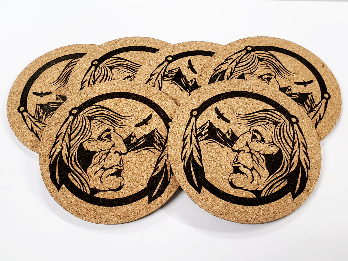 Stack of round cork coasters printed in black with a Chief A design: a face in a feathered headdress