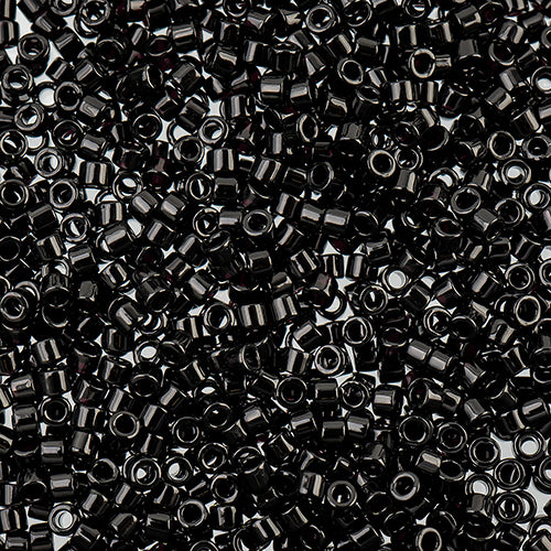 Close-up of Miyuki Delica 11/0 DB0010 cylinder beads in opaque black