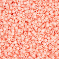 Close-up of Miyuki Delica 11/0 DB0207 cylinder beads in opaque peach with a luster finish