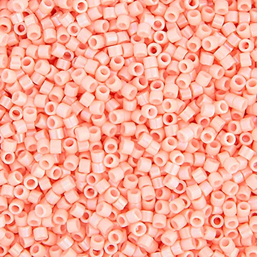 Close-up of Miyuki Delica 11/0 DB0207 cylinder beads in opaque peach with a luster finish