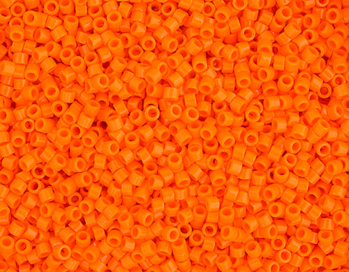 Close-up of Miyuki Delica 11/0 DB0722 cylinder beads in opaque orange