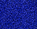 Close-up of Miyuki Delica 11/0 DB0726 cylinder beads in opaque cobalt blue