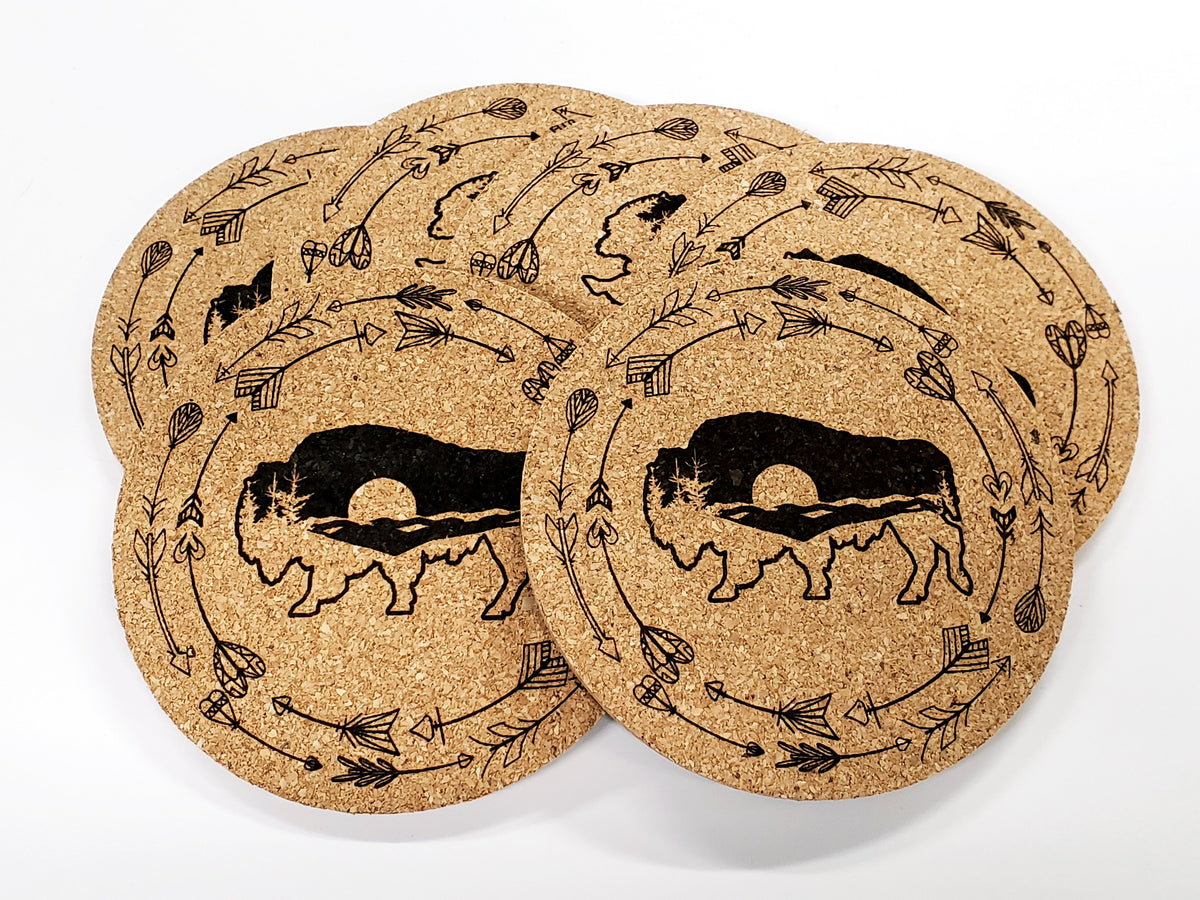 Stack of round cork coasters printed in black with a bison silhouette with a beaded border