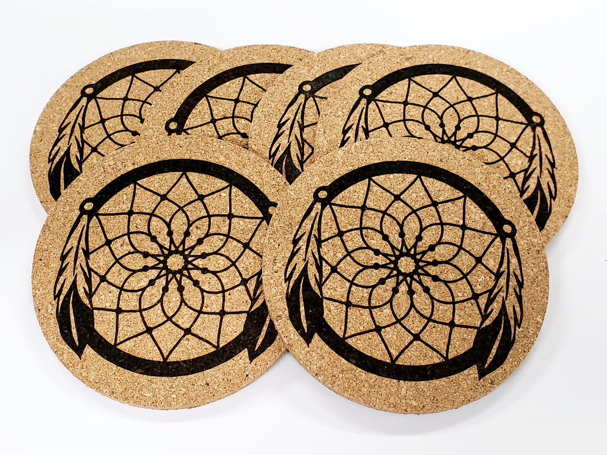 Stack of round cork coasters printed in black with a dream catcher with hanging feathers