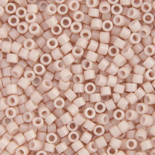 Close-up of Miyuki Delica 11/0 DB1495 cylinder beads in opaque pink champagne